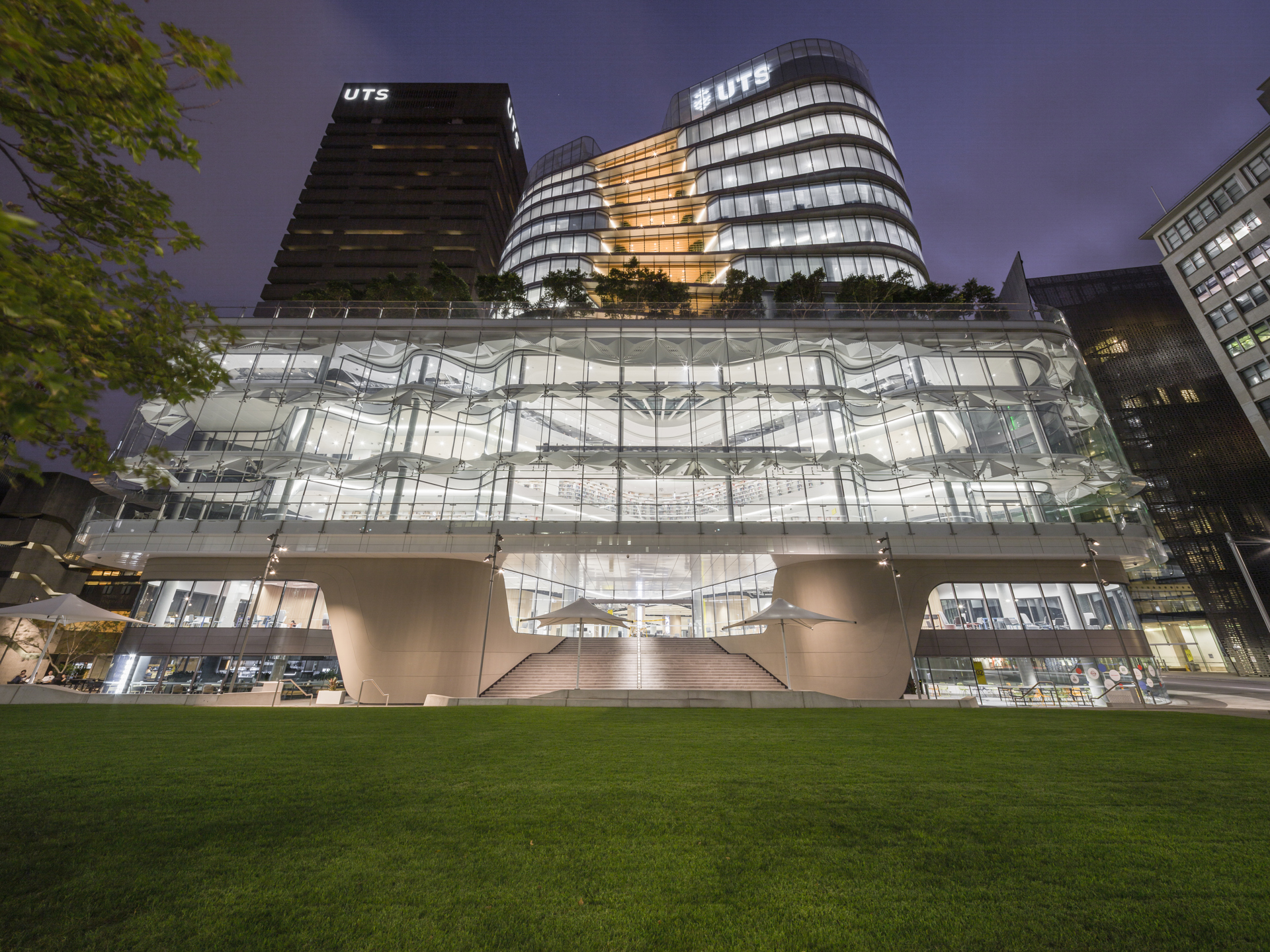 University of Technology Sydney Central building at night.